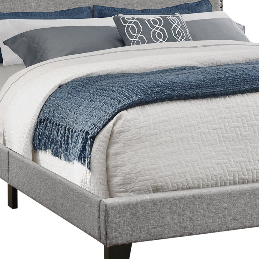 Beige Standard Bed Upholstered With Nailhead Trim And With Headboard