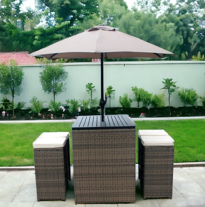 Six Piece Brown and Tan Faux Wicker Outdoor Bar Height Table Set with Umbrella and Stools