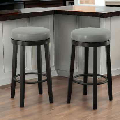 Set of Two 30" Gray And Espresso Faux Leather And Solid Wood Swivel Backless Bar Height Bar Chairs